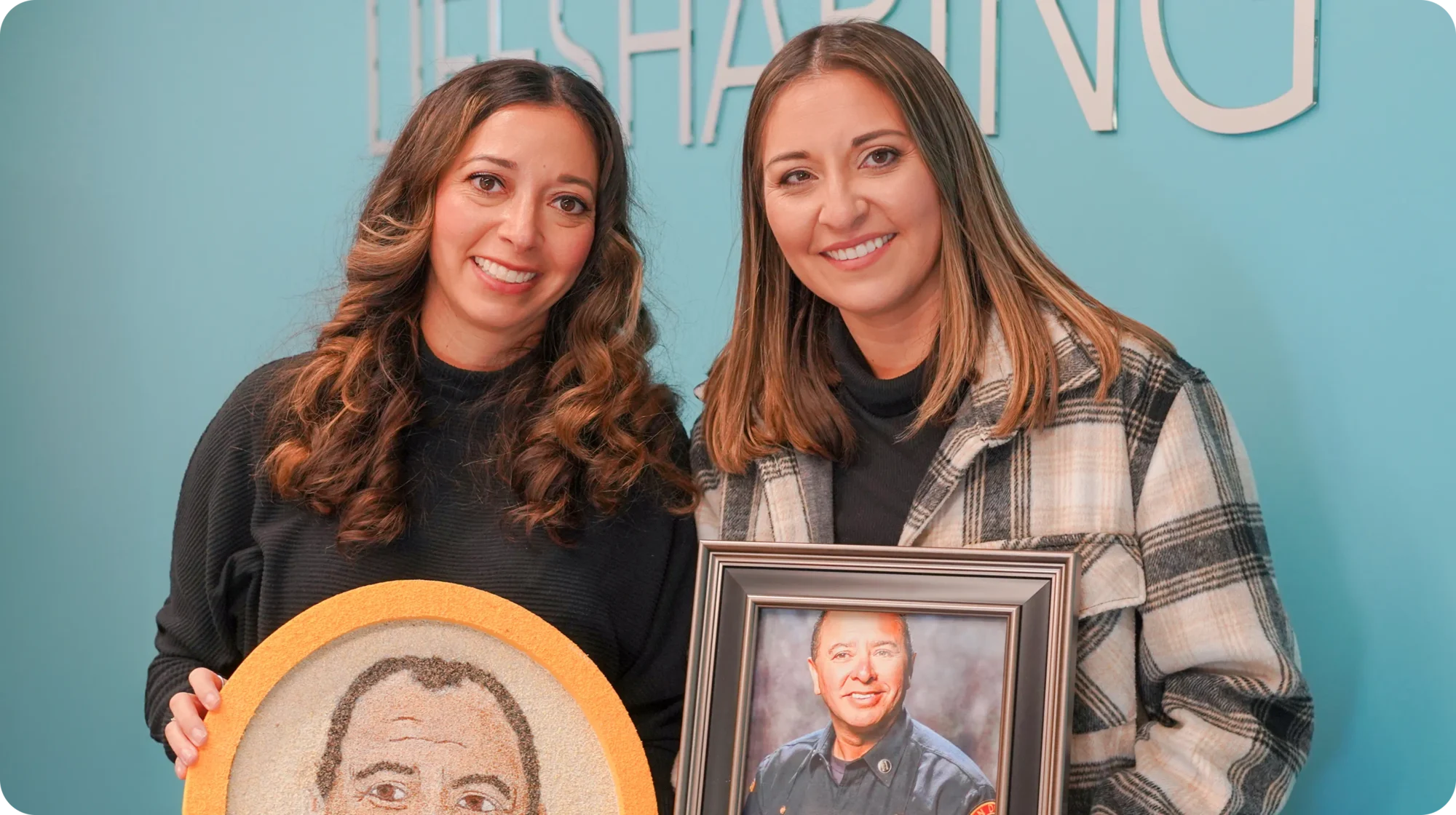 Monique Pascucci and Nadia Powell hold photos of their father