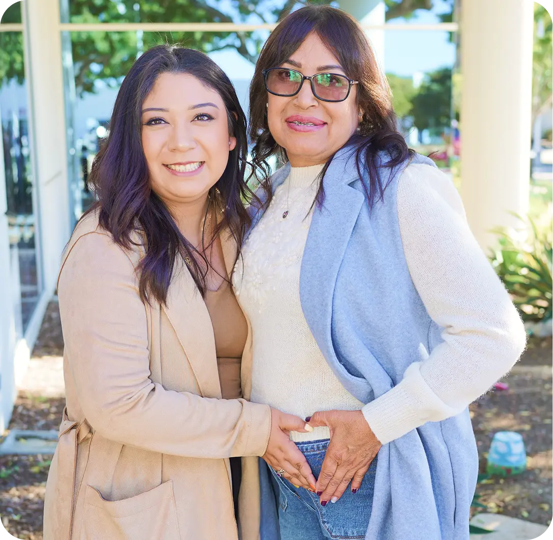 two women stand together
