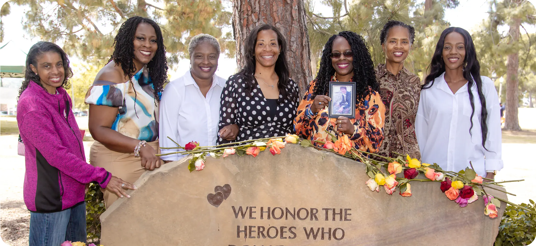 A group of women standing at a memorial site