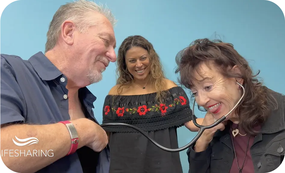 Woman uses a stethoscope against a mans chest